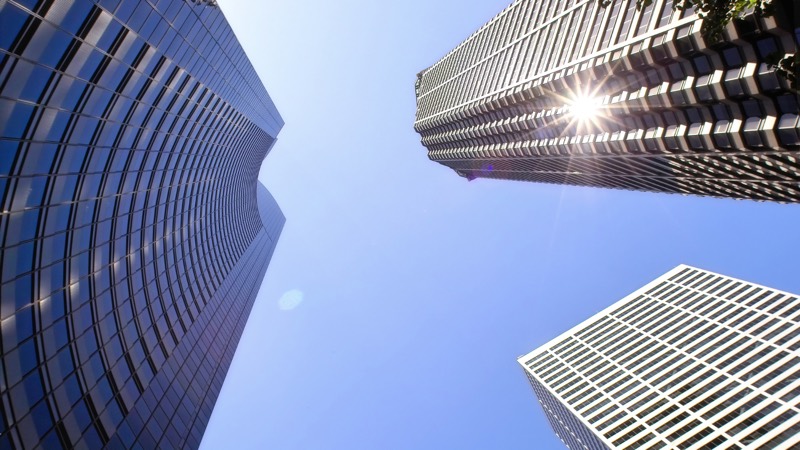 Sunlight breaking between office towers